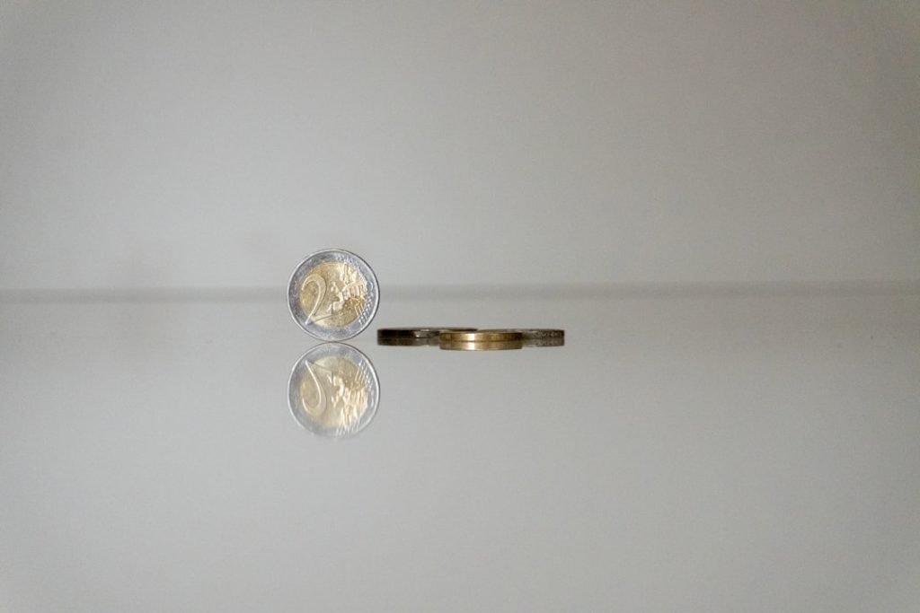 a-gold-ring-with-a-coin-on-top-of-it-ahs0wwjusog